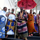 Traditional ruler of Abomey-Calavi, Kpoton Avounbe, Allodji III, (C) and his family arrive to attend the inauguration of a symbolic exhibition to showcase artefacts looted by the French colonial soldiers returned to the country at the presidency in Cotonou on February 19, 2022